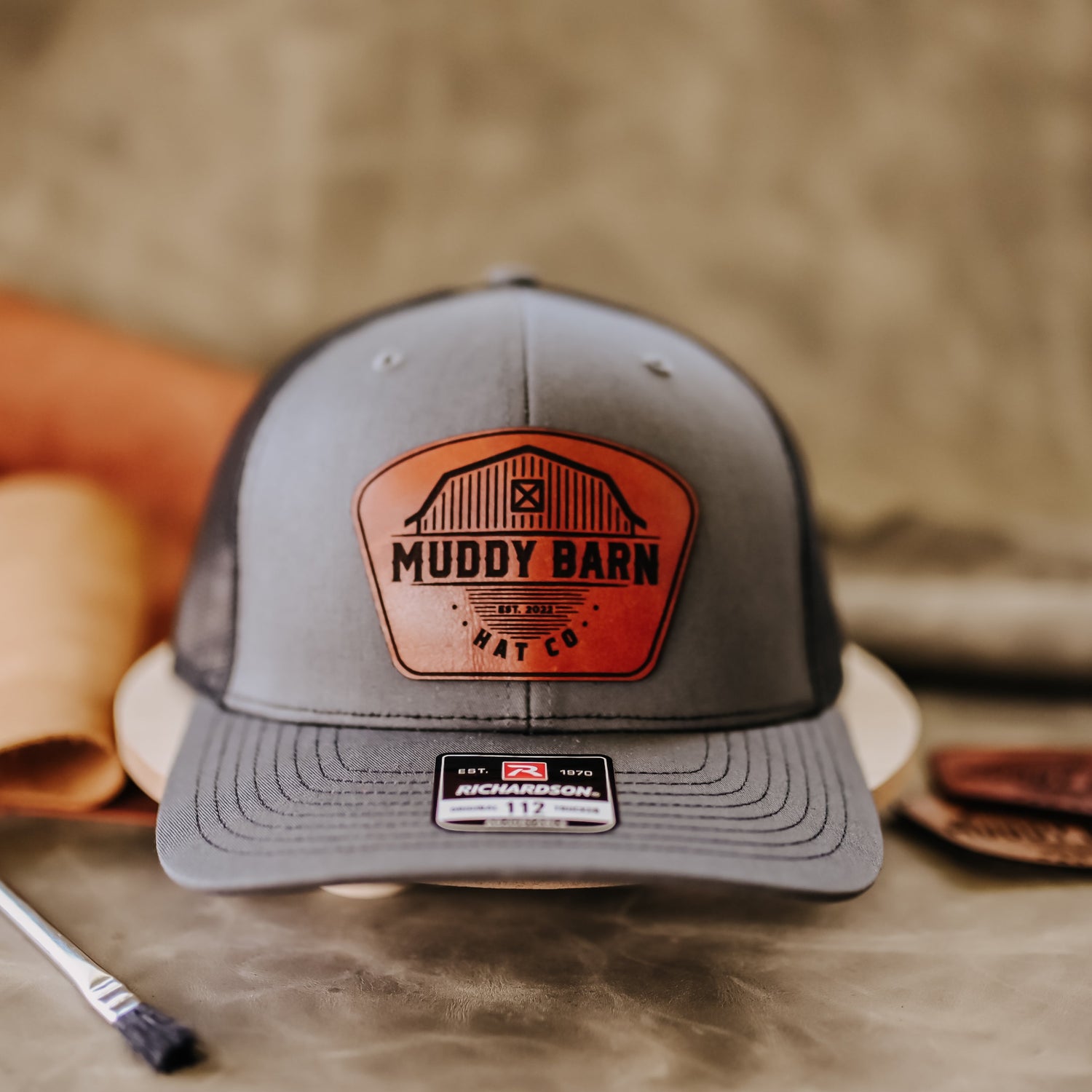 Muddy Barn logo on rust leather. Charcoal/black Richardson 112